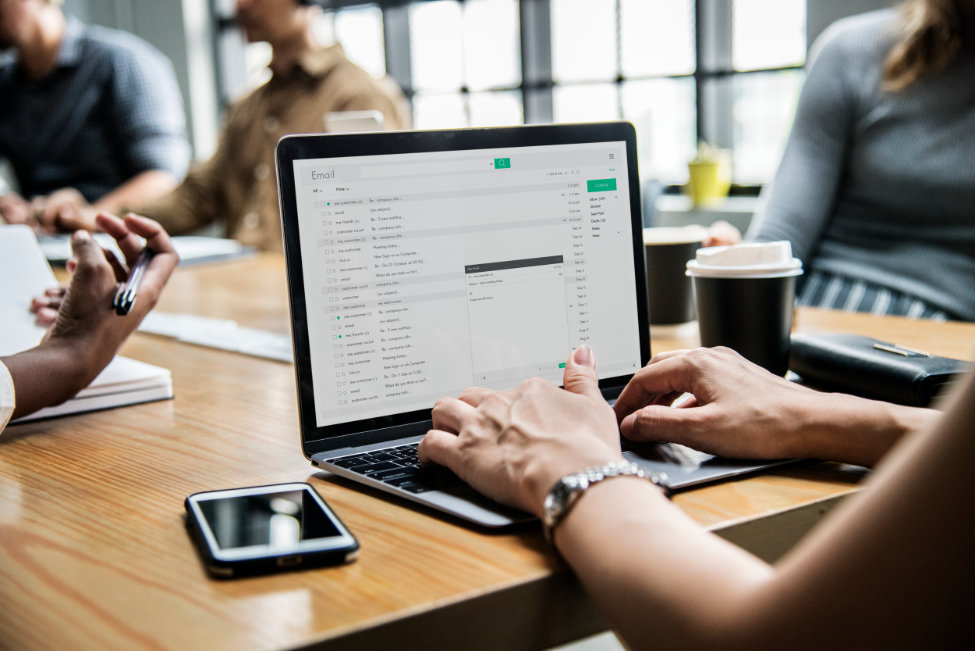 Woman using an email group service in a meeting