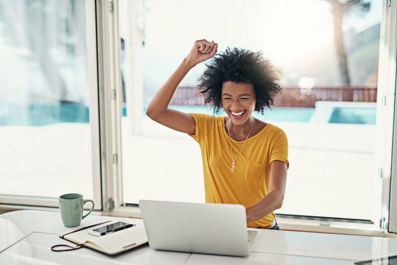A woman happy in front of her laptop