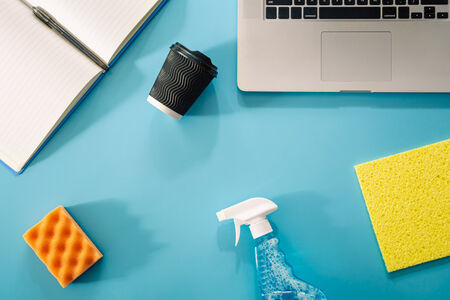 An image showing cleaning products next to a computer