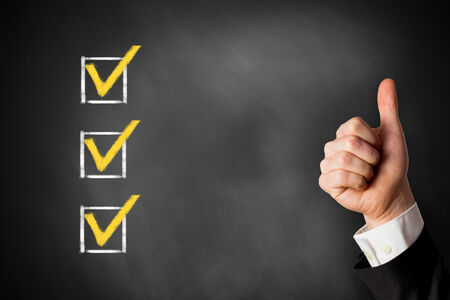 An image of a blackboard with ticked checkboxes and a thumbs-up next to them