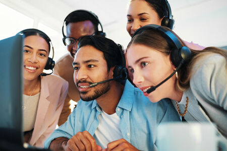 An image showing a group of people crowded around a computer