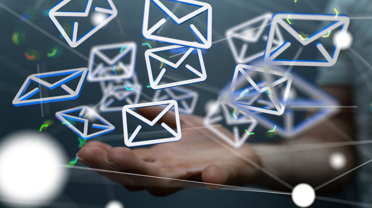 Comprehensive and robust hosting is needed for a large email system An image showing lots of emails being held in a hand